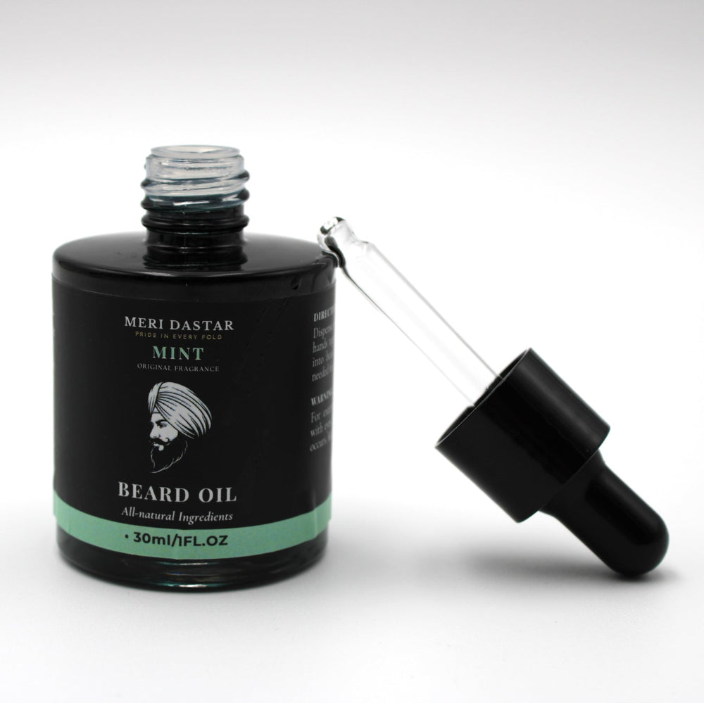 Beard oil bottle with dropper on a white background