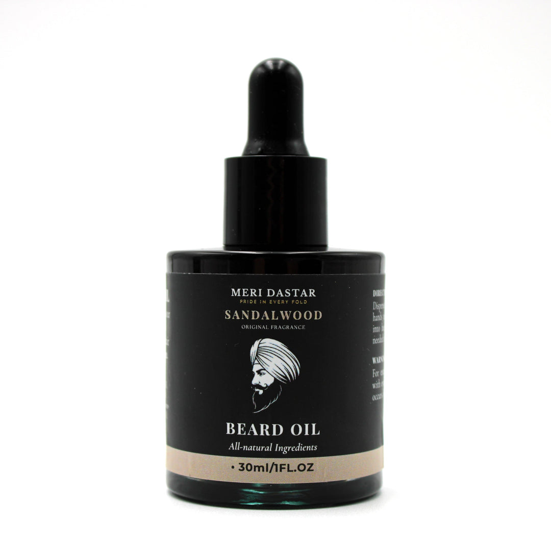 Beard oil dropper bottle with black label on a white background