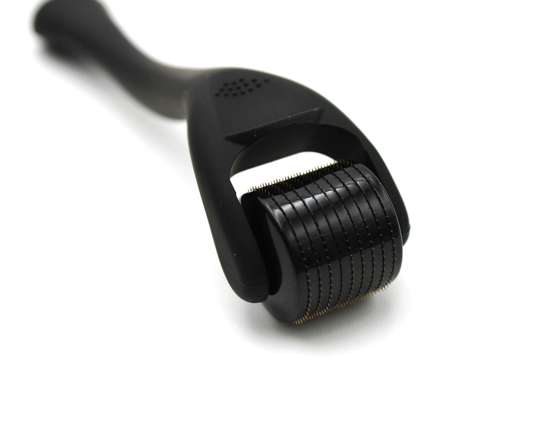 Black derma roller on a white background