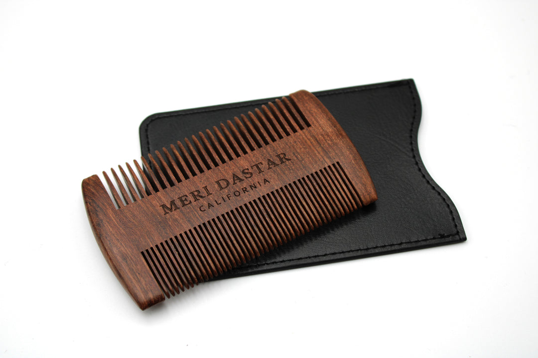 Wooden comb with black case on a white background