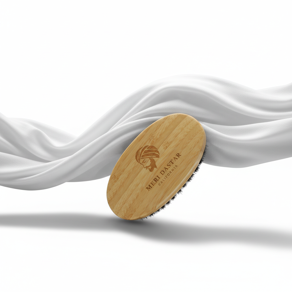 Wooden brush with black bristles and 'Meri Dastar California' branding on a white background